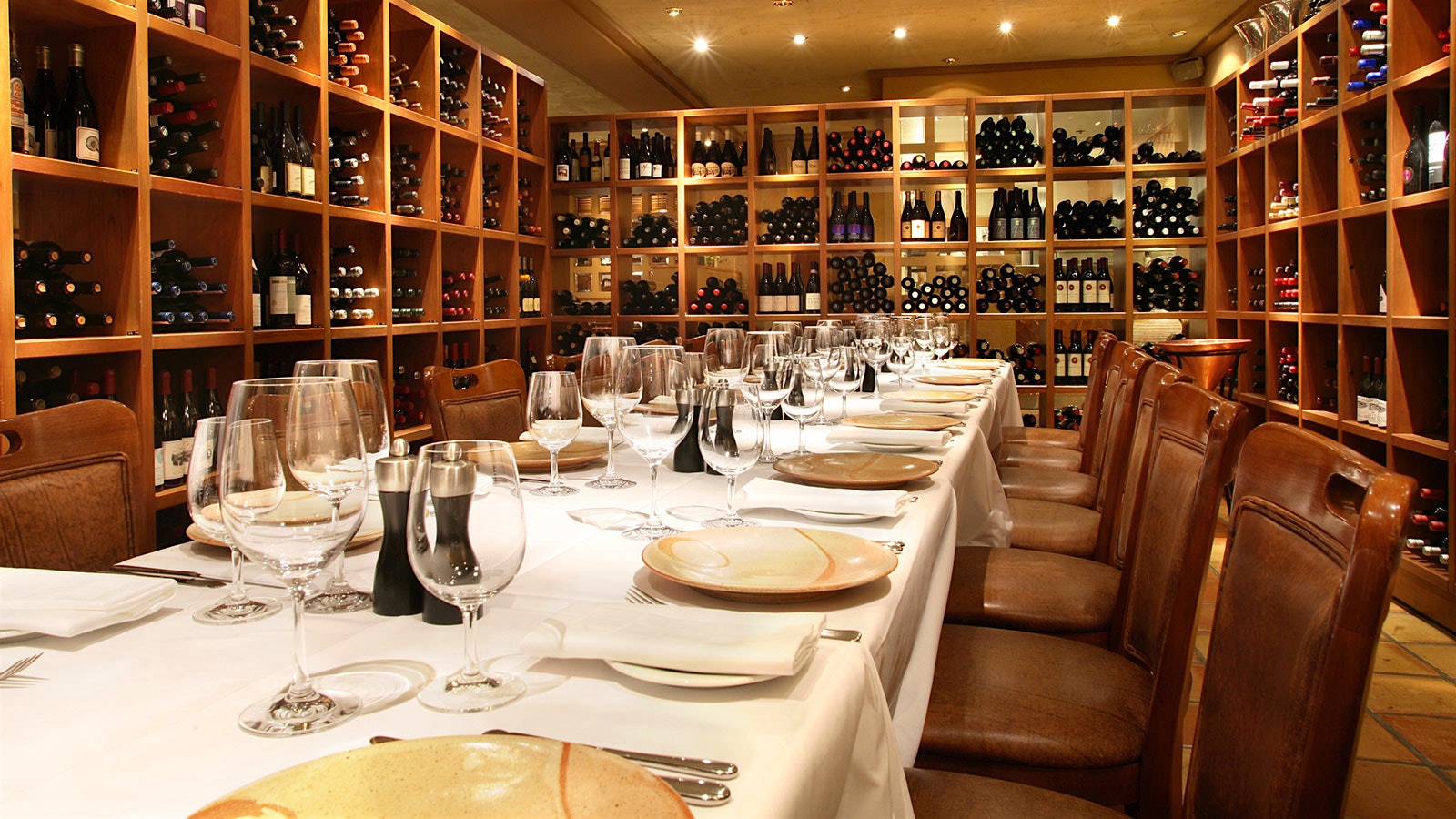The wine room at Araxi with a set table